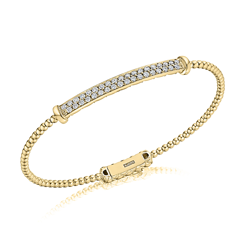 Flexible bangle with diamonds and quilted detail on the inside. With lock