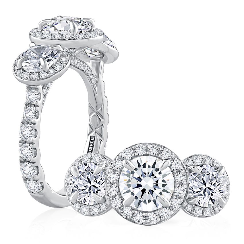 Round diamond three stone ring with diamond halos and diamonds down band
